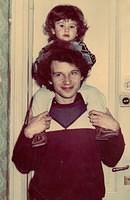 Unknown Komar man with child on shoulders.jpg